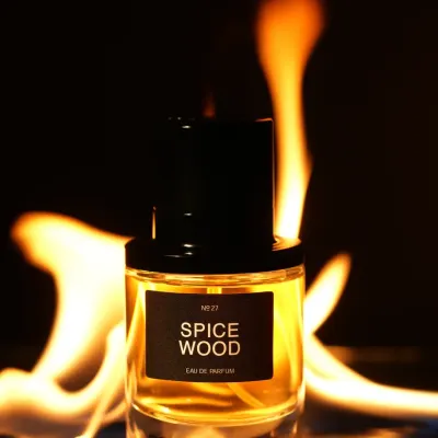 A bottle of 'Spice Wood' perfume dramatically lit with real flames in the background. We use practical effects like fire and smoke to create bold, powerful images for masculine fragrances.