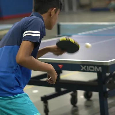 A student sharpens his forehand technique during a practice match. We use our professional XIOM and STAG tables to give players a real tournament feel and build their confidence.