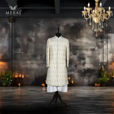 This off-white silk sherwani is a masterpiece of understated luxury. The entire surface is adorned with intricate Poth Zardozi detailing, creating a rich texture that is both classic and sophisticated.