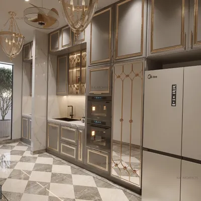 A different angle of our serene and elegant kitchen. This view highlights the built-in ovens, the custom mirrored pantry door with golden iron detailing, and the beautiful chequered marble floor.