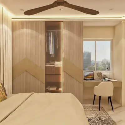 This bedroom design seamlessly integrates a wardrobe with a compact study nook by the window. The fluted and chevron-patterned wardrobe doors add a layer of texture, while the built-in desk provides a functional workspace with ample natural light.
