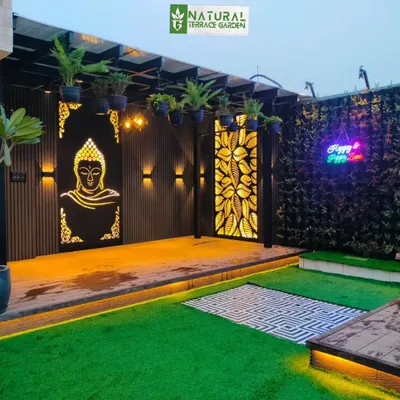 A custom-made, backlit Buddha jaali panel serves as a peaceful and artistic focal point in this Uttam Nagar pergola.