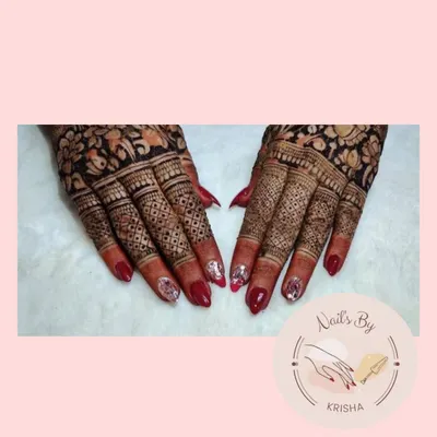 A beautiful bridal nail set featuring a classic red polish and accent nails with encapsulated silver glitter to match the wedding attire.