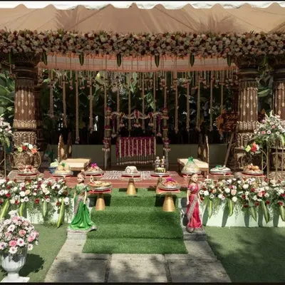 This stunning outdoor muhurtham mandap combines traditional architecture with an abundance of fresh flowers for a magical ceremony setting.