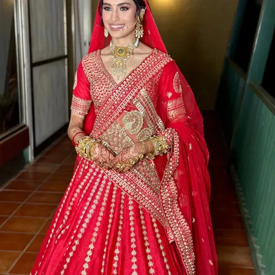 The quintessential Indian bride, radiant in a classic red lehenga. I focused on creating a luminous base and soft, defined eyes to let her natural beauty and the richness of her outfit shine.