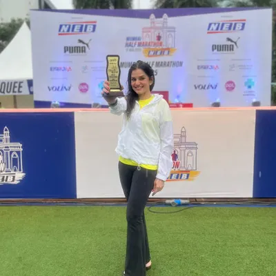 Celebrating Dr. Indu Tandon's 3rd place finish in the Women's Open Category at the Mumbai Half Marathon. A proud moment holding the trophy that represents all the hard work.