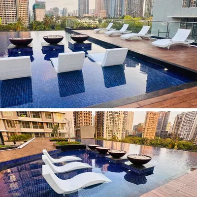 The rooftop pool at Ekta Tripolis in Goregaon, Mumbai. We designed this space to be a true urban escape, with in-water lounge chairs and a stunning view of the city skyline, offering residents a resort-like experience at home.
