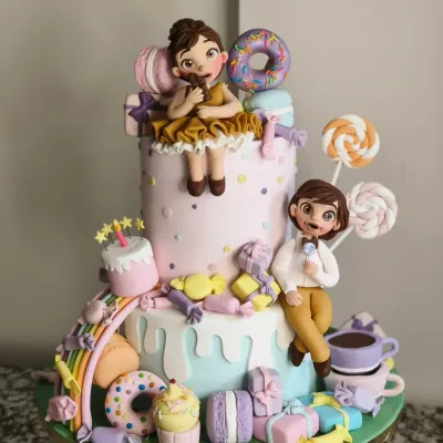 This Candyland themed cake was an absolute joy to make. The design features two tiers of cake adorned with handcrafted fondant characters, donuts, macarons, and candies, creating a vibrant and playful centerpiece for a twin's birthday party.