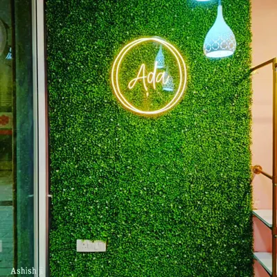 This is a custom green wall I created for a retail store, featuring their brand logo in neon. This is an effective way to create a branded photo opportunity for customers.