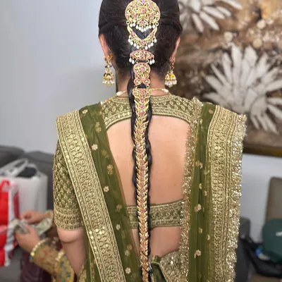 A classic traditional bridal braid for a Sabyasachi bride. I used an elaborate gold jadau hair accessory that covers the entire length of the braid, creating a look of pure royalty and heritage for her wedding day.