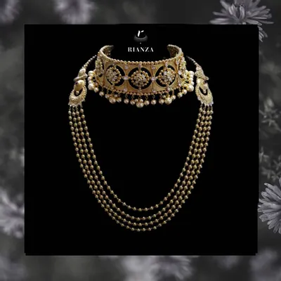 A complete Rajwadi bridal set. This features a wide kundan and pearl choker with a matching multi-string pearl and gold bead necklace, designed to be worn together for the main ceremony.