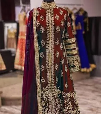 A floor-length Anarkali-style gown on a mannequin, showcasing intricate embroidery from top to bottom. This is a perfect outfit for a wedding reception or formal party.