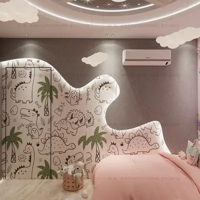 A close-up of the unicorn-themed bed area, featuring a pink color scheme, a unicorn-shaped neon light, and a custom headboard with a dinosaur pattern, blending two themes in one room.