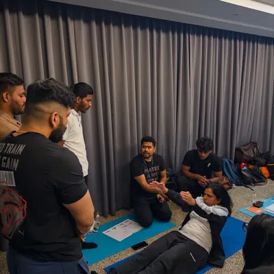 A typical scene from our Mat Teacher Training course, where students learn by doing. You'll be actively participating, observing, and practicing your teaching cues in a supportive group environment.