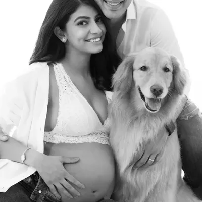 A powerful black and white family portrait. Removing the color focuses the viewer's attention on the love and connection between the couple and their dog.