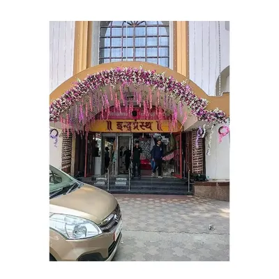 We designed this elegant floral arch for the entrance of the Indraprastha Shopping Center in Borivali. The use of hanging purple and pink flowers created a sophisticated and welcoming look for shoppers.