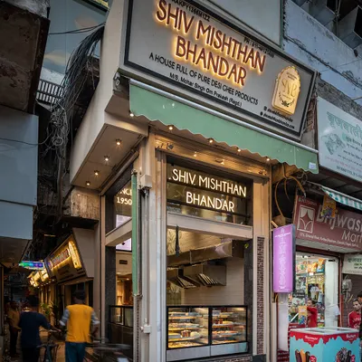 The exterior of Shiv Mishthan Bhandar in Chandni Chowk. The renovated facade uses materials like red stone and lakhori bricks, inspired by the architecture of old havelis, to blend seamlessly into its historic context.