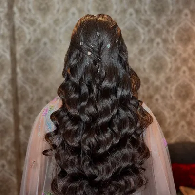 A look at the beautiful, voluminous waves created for this client. This hairstyle is perfect for a reception or cocktail party, adding a touch of glamour and movement.