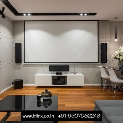 You don't need a dedicated room to have a spectacular home theater. Here, we integrated a full projection screen, console, and speaker system into a modern living and dining area. This setup proves that high-performance entertainment can coexist beautifully with contemporary interior design.