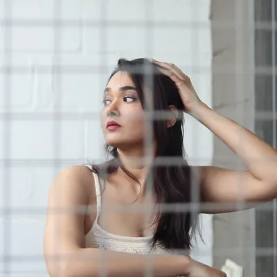 A creative portrait shot through a wire mesh. This technique adds texture and an editorial feel to the image.