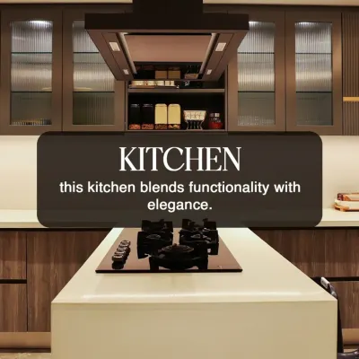 This kitchen blends elegance with functionality. The design features an island with a built in cooktop, a powerful chimney hood, and fluted glass cabinets for a sophisticated touch.