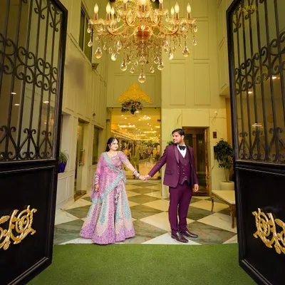 A grand entrance shot of the couple at their ring ceremony. The wide angle captures the beautiful venue and chandelier, making for a stunning photograph.