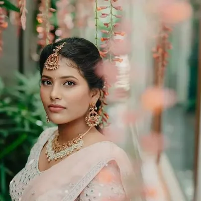 A fresh, minimalistic makeup look captured in a beautiful, serene setting. This shows how a natural makeup style can be effortlessly elegant and perfect for a daytime event.