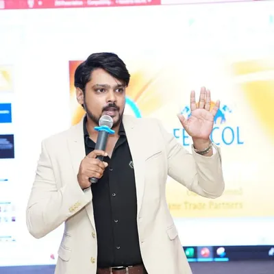 Addressing the audience at a Fevicol Dealers Meet. For brand events, I maintain a professional tone while ensuring the key messages are delivered with clarity and impact.