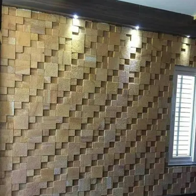 This 3D stone cladding creates a stunning visual effect with its varied depths and clean lines. The addition of overhead spotlights enhances the shadows, making it a dynamic feature wall that changes throughout the day.