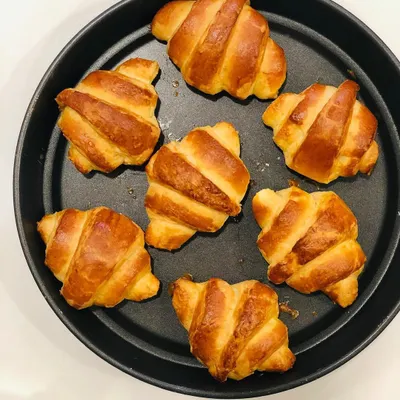 A tray of my freshly baked croissants, golden brown and beautifully layered. I make these the traditional way with laminated dough, and I love the outcome.