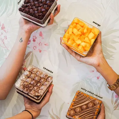 Our cake tubs are perfect for a party of one. Here are four of our most popular eggless flavors: Choco Raspberry, seasonal Mango, classic Tiramisu, and Nutty Salted Caramel.