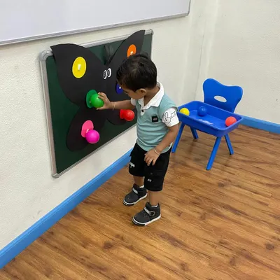A young explorer interacts with our butterfly color matching board. This activity is part of our curriculum that uses nature themes to teach fundamental concepts like colors and counting.