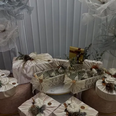 An example of a winter-themed trousseau setup using fabric wrapping, a technique we cover in detail. Notice the use of natural elements like pinecones and dried flowers to create a cohesive, luxurious look.