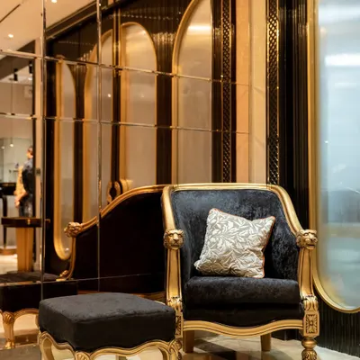 In this jewelry boutique, I used a bold combination of black velvet and gold-leafed frames for the seating. This pairing creates a sense of drama and opulence, inviting customers to sit and immerse themselves in the luxury experience.