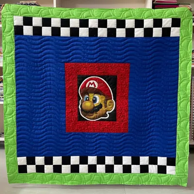 It's-a-me, Mario! We had so much fun doing the longarm quilting on this Super Mario themed quilt, using different patterns to highlight each section.