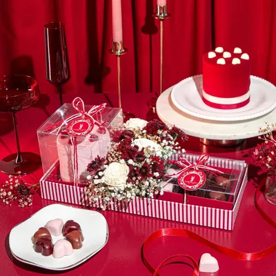 A romantic tablescape featuring our Valentine's Day collection. This hamper includes a mini red velvet cake, heart-shaped chocolates, and fresh flowers, all set for a celebration of love.