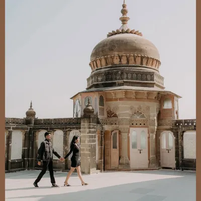 We create timeless portraits against backdrops of history and grandeur. At the magnificent Vijay Vilas Palace, we captured this couple walking hand-in-hand, their modern love story framed by the palace's majestic architecture.