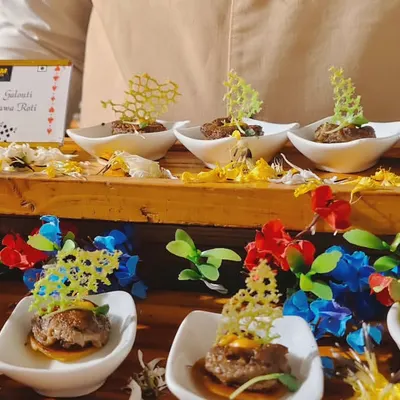 An example of our gourmet Indian appetizers. This dish features delicate Mushroom Galouti kebabs served on miniature Ulta Tawa Rotis, garnished with an intricate, crispy lattice for a touch of modern artistry.