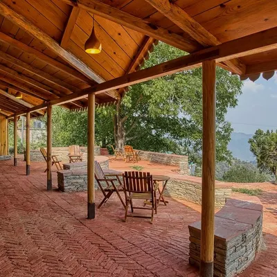 The outdoor cafeteria at Sargakhet Handicraft Centre in Mukteshwar, set on a terrace with brick flooring. This space was created by transforming a dilapidated British-era Post Office into a hub for local artisans.