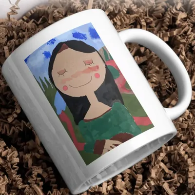 This beautiful mug features a portrait drawn by a child, printed with sharp detail and vibrant colors. It’s a functional piece of art that makes every sip of tea or coffee feel special.