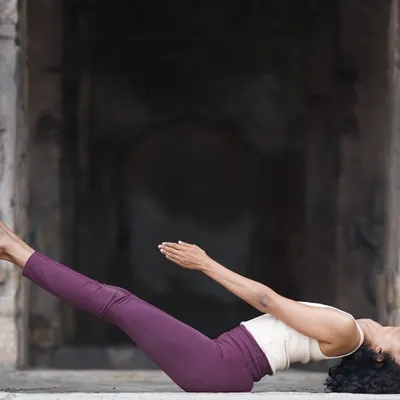 A photo of Matsyasana (Fish Pose) in a historic setting, reminding us that growth begins with one small step forward.