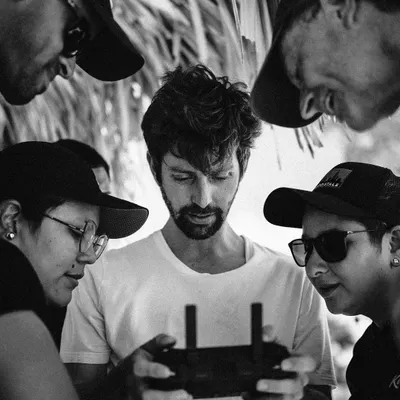 On set with the crew, reviewing drone footage. Collaboration is a key part of larger productions. Using a drone allows for perspectives that can completely change the feel of a film.