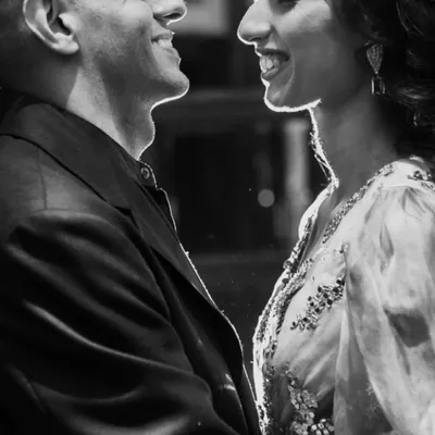 A perfect example of a cinematic black and white moment. The beautiful rim lighting outlines the couple's faces, creating an intimate and romantic portrait.