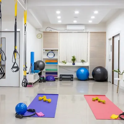 A wide view of my studio, showcasing the versatile equipment we use, including TRX, stability balls, Pilates rings, and mats. The space is designed to be welcoming and functional for both group classes and private sessions.