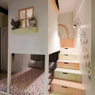 This house-shaped bed is more than just a place to sleep. The stairs double as storage drawers, and the window on the upper level creates a perfect perch for imaginative play.