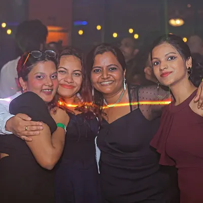 Spinning tracks and spreading joy. A happy group of friends enjoying the music and the atmosphere.