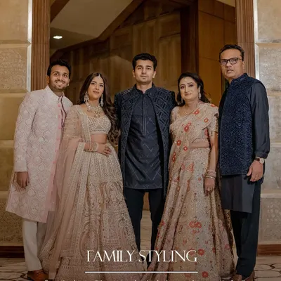 From timeless traditions to trendsetting looks, we style your entire family with love and flair. Here, we balanced deep blues for the men with soft beige and blush for the women, creating a harmonious and elegant family portrait.