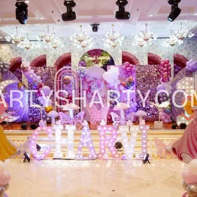This elaborate stage for a princess and butterfly theme is a perfect example of our detailed work. It features multiple arches, marquee letters, character cutouts of Disney princesses, and a sequin backdrop for a truly royal celebration.