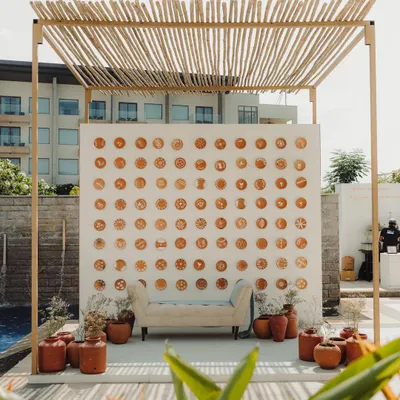 For this Champagne brunch, we created a photo backdrop using hand-painted pottery plates with Rangoli designs, surrounded by terracotta pots to evoke the feeling of a grandmother's courtyard.