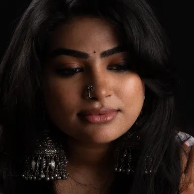A moody studio portrait where the makeup is key. I used a soft, smoky eye and a nude lip to create a look that is both gentle and striking against the dark background.